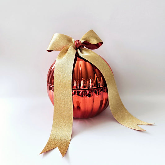 Red Christmas bauble candle with golden ribbon